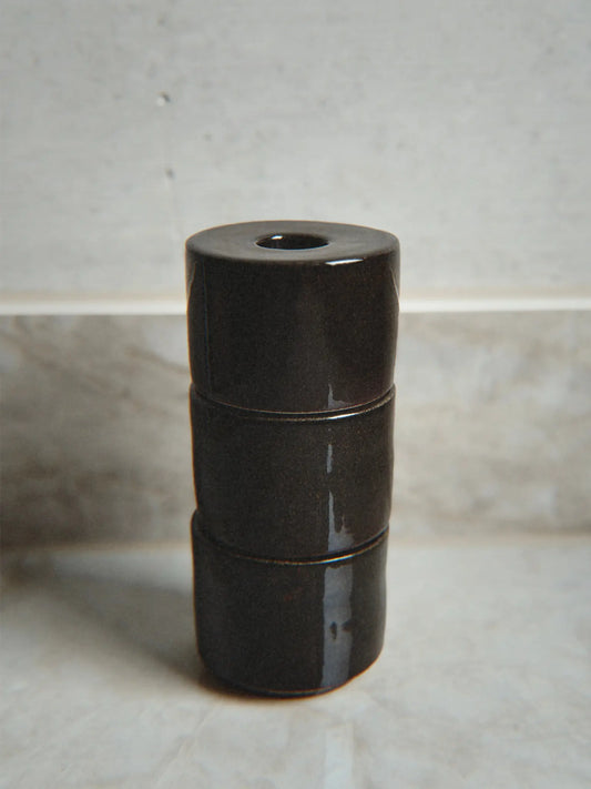 Kerzenhalter Modu in braun gestapelt auf einem Marmor Hintergrund.