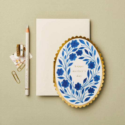 Muttertgskarte Happy Mother's Day mit einem blauen Blumenmotiv und goldigen Rand auf einem hellen Hintergrund.
