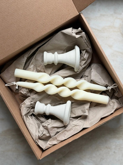 Geschenkset bestehend aus einem 2er-Set gedrehter Stabkerzen und zwei Kerzenhalter aus Keramik.