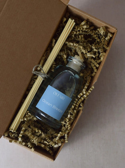 Raumduft mit ozeanblauem Etikett mit Stäbchen in einer Box.