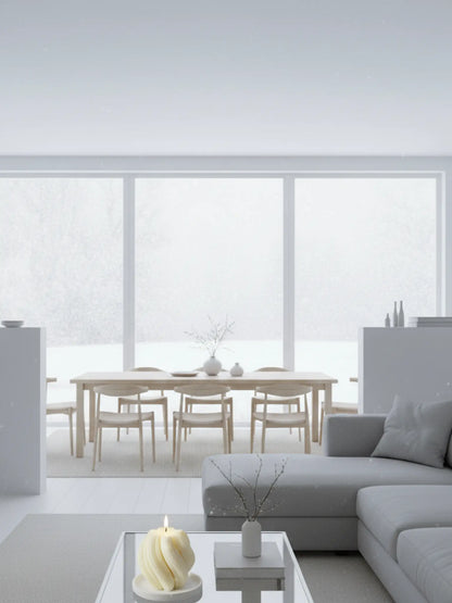 Spiralförmige Kerze in einem hellen Wohn- und Esszimmer. Die Kerze steht auf einem Couchtisch.